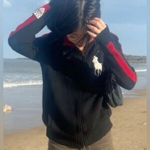 black knit polo with red striped arms USA